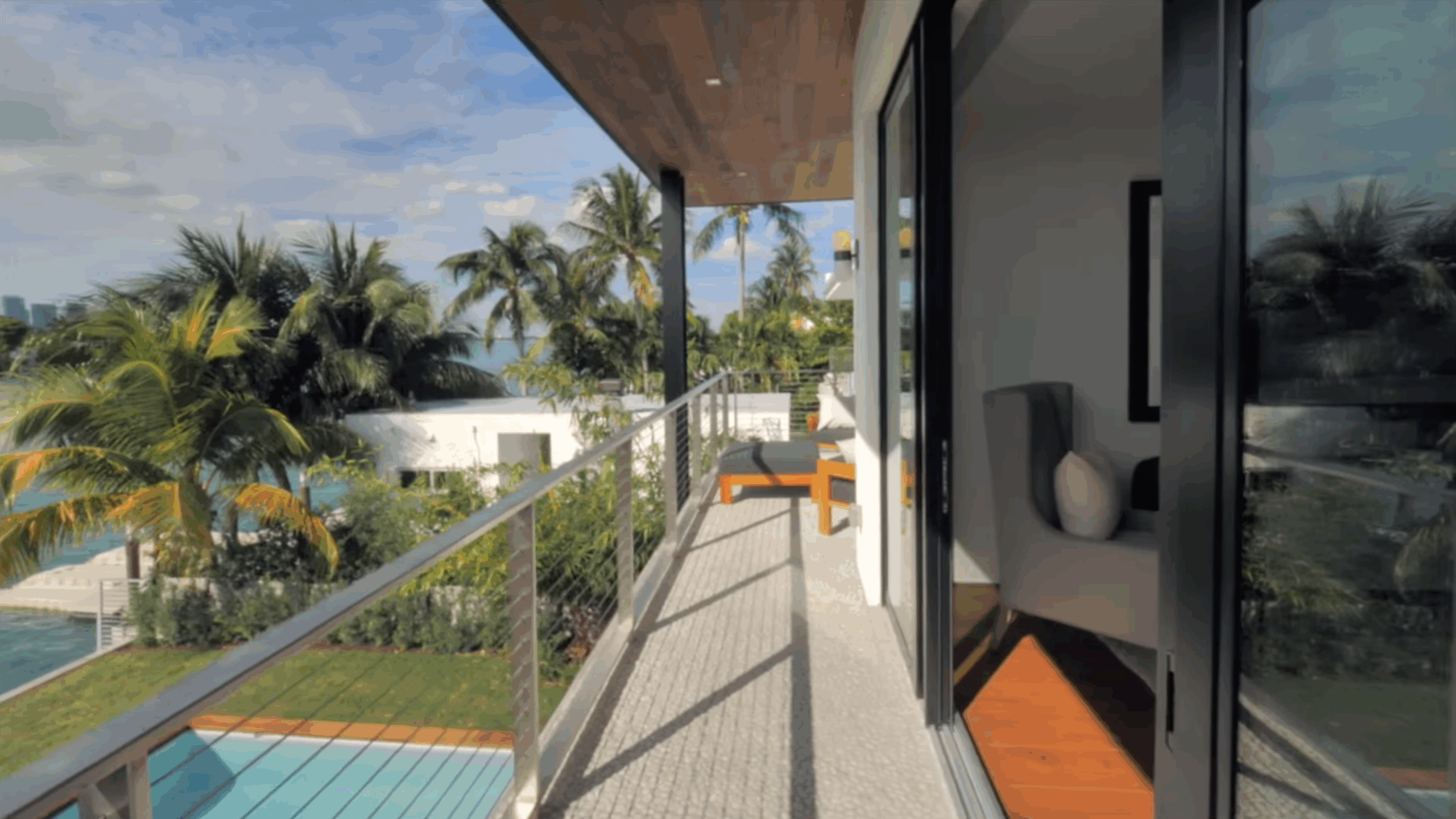 Luxury home in Miami with new Impact Window sliding doors on a balcony