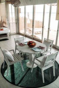 Shot of a furnished dining room outfitted with sliding impact glass doors