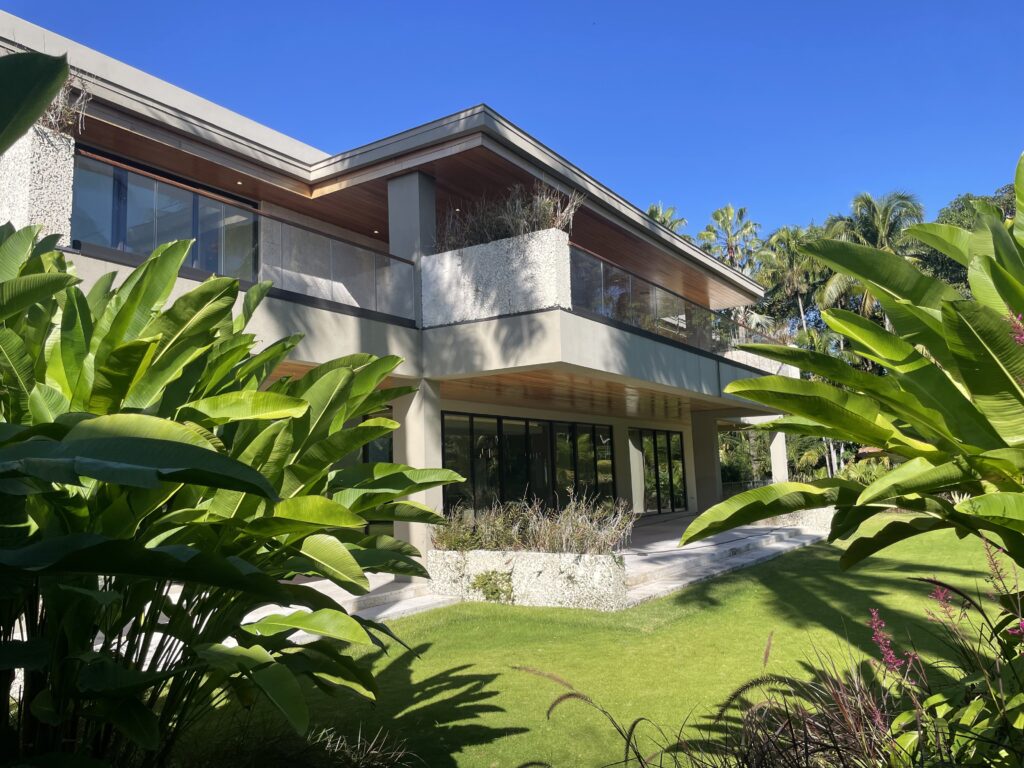 Scenic fauna backyard shot of a luxury South Florida residential building with impact windows installed