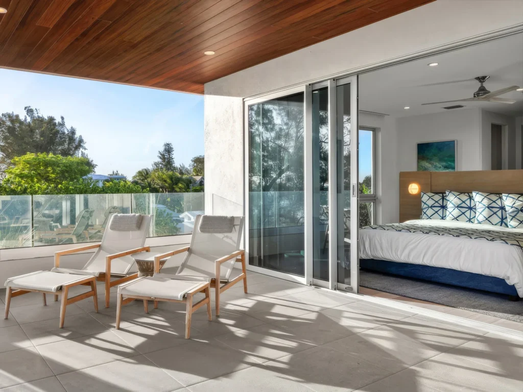 Master bedroom balcony view of a South Florida home with impact windows and sliding doors installed